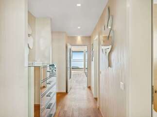Step into this elegant hallway featuring a mirrored dresser and unique cactus-shaped wall mirrors, adding a touch of modern flair.