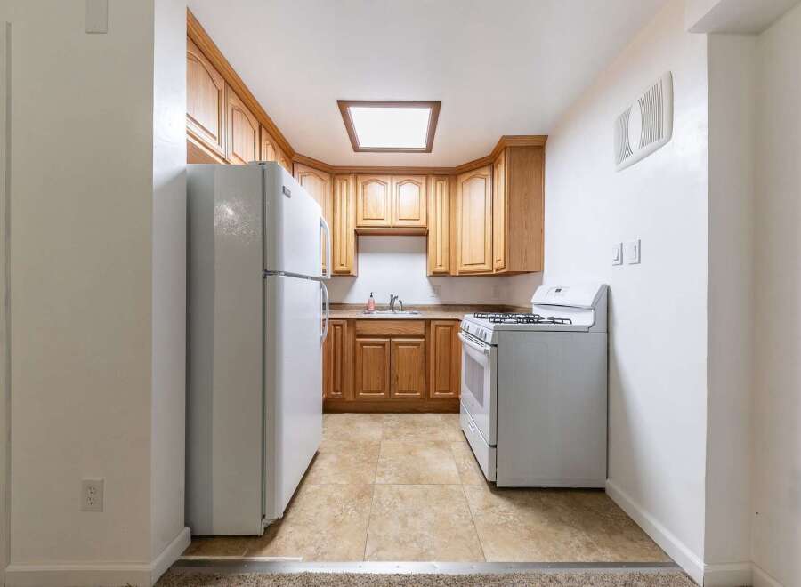 Discover this charming kitchen featuring warm wooden cabinetry and a functional layout.