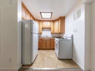 Discover this charming kitchen featuring warm wooden cabinetry and a functional layout.