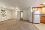 Discover comfortable living in this spacious apartment featuring a large, carpeted living area perfect for relaxation and entertainment.