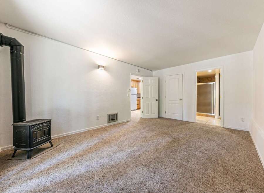 Cozy living space featuring a charming black wood-burning stove, perfect for chilly evenings.