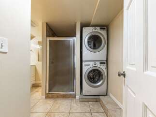 Discover the convenience of in-unit laundry with this stacked LG washer and dryer set, perfectly integrated into a compact laundry nook.