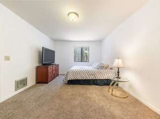 This cozy bedroom features a comfortable bed with a chevron-patterned comforter, perfect for a restful night's sleep.