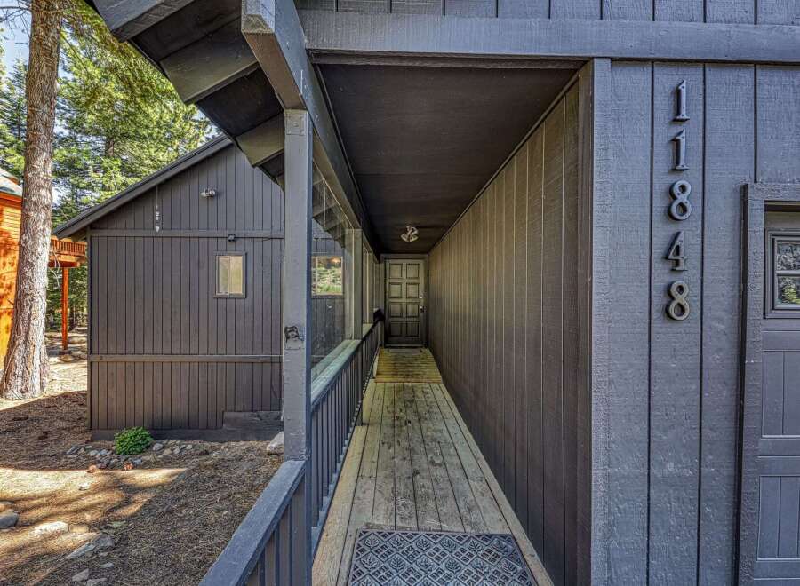 Discover this charming property featuring a welcoming covered walkway leading to the front entrance.