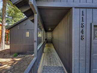 Discover this charming property featuring a welcoming covered walkway leading to the front entrance.