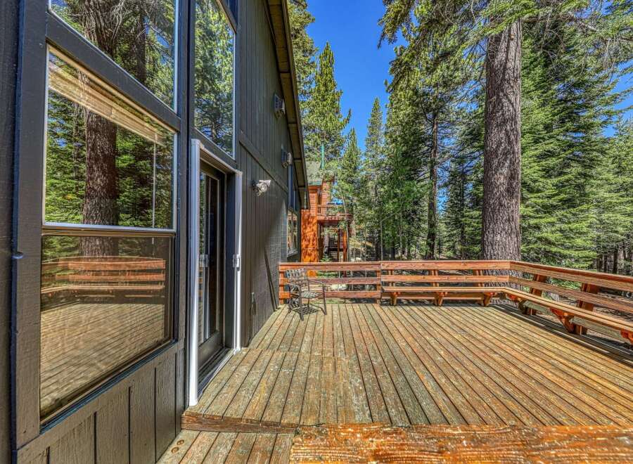 Enjoy the serene mountain setting from this expansive wooden deck, perfect for outdoor entertaining or quiet relaxation.