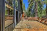 Enjoy the serene mountain setting from this expansive wooden deck, perfect for outdoor entertaining or quiet relaxation.