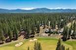 Experience luxury living nestled amidst a pristine pine forest, offering breathtaking mountain views.