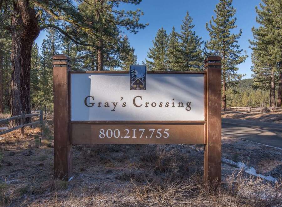 Discover Gray's Crossing, a premier real estate development nestled amidst the natural beauty of tall pine trees.