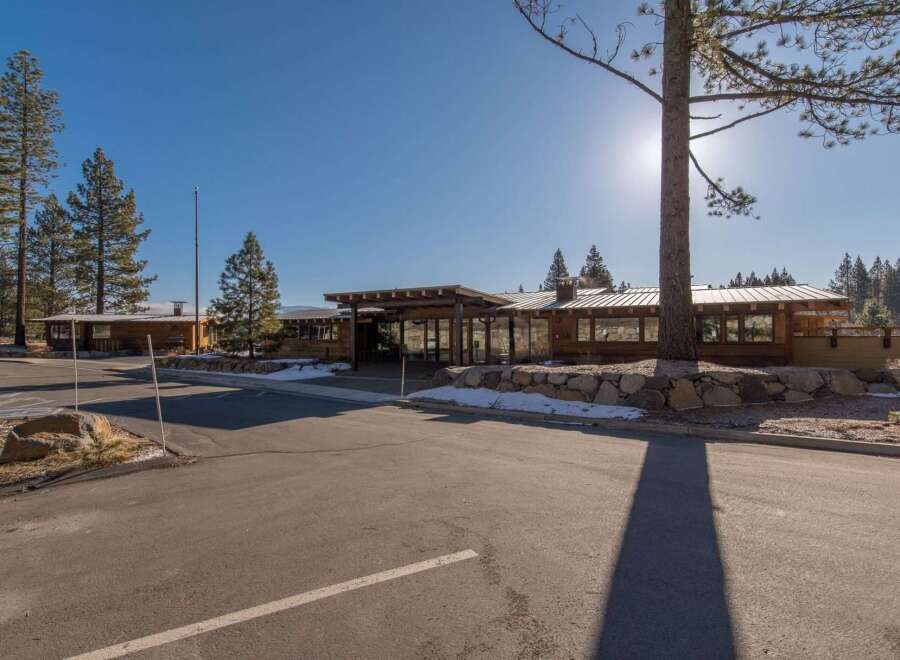 Discover this stunning property featuring a modern architectural design with natural wood accents and a sleek metal roof.