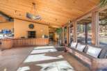 Experience a warm welcome in this inviting lobby featuring a rustic wooden reception desk and a comfortable seating area.