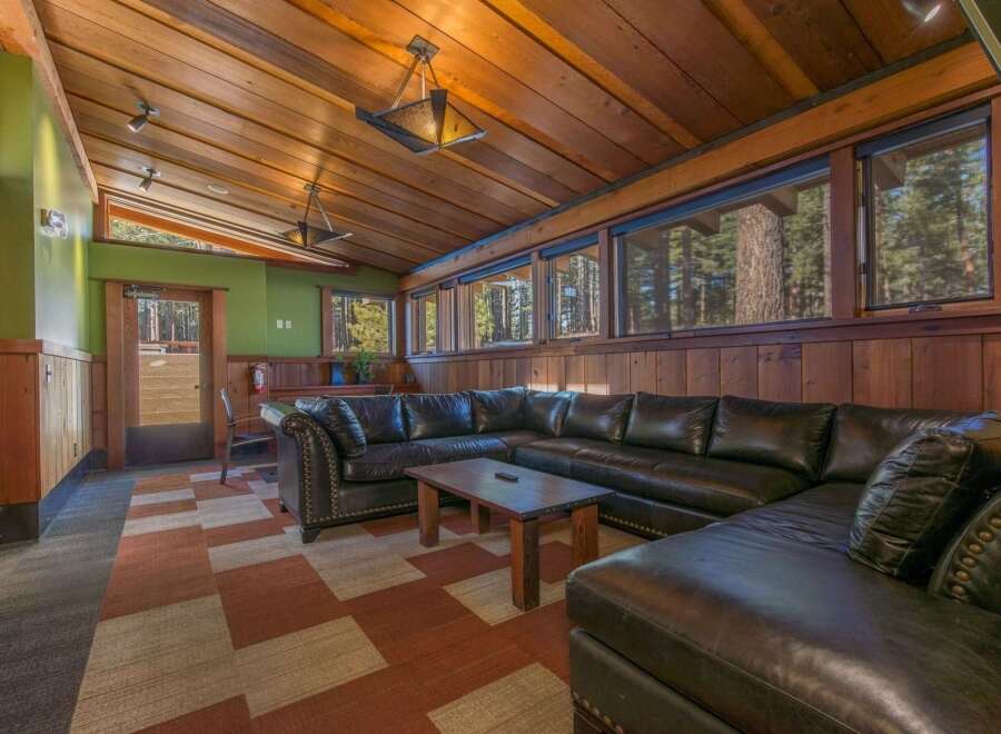 Experience rustic charm in this spacious living area, featuring a large sectional sofa perfect for gatherings.