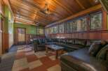 Experience rustic charm in this spacious living area, featuring a large sectional sofa perfect for gatherings.