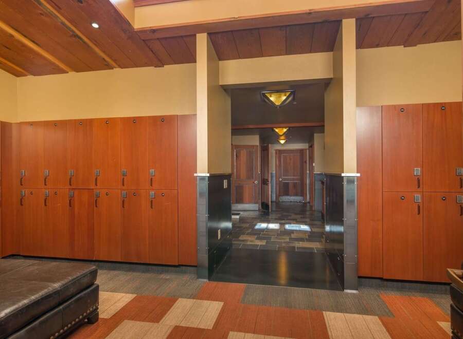 Step into a world of refined comfort with this beautifully appointed locker room, featuring rich cherry wood lockers equipped with digital locks for ultimate security and convenience.