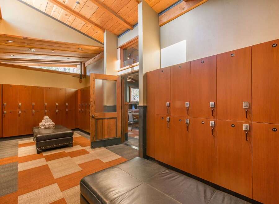 Experience luxury and convenience in this beautifully appointed locker room, featuring rich wood lockers with digital locks for enhanced security.