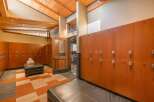 Experience luxury and convenience in this beautifully appointed locker room, featuring rich wood lockers with digital locks for enhanced security.