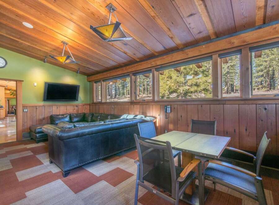 Experience rustic charm in this inviting living space, featuring a plush leather sectional sofa perfect for relaxation.