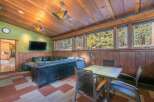 Experience rustic charm in this inviting living space, featuring a plush leather sectional sofa perfect for relaxation.