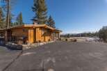Experience rustic charm in this beautifully crafted wooden home, nestled amidst towering pine trees.
