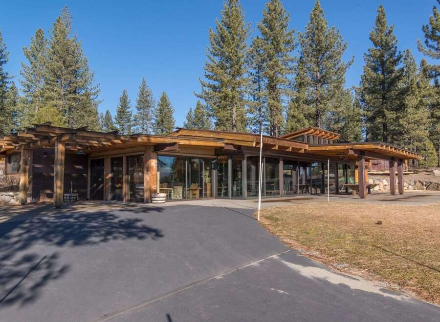 Experience modern living in this stunning home featuring expansive glass walls that seamlessly blend indoor and outdoor spaces.
