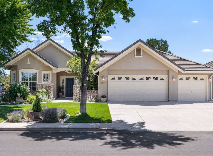 Discover this charming single-story home featuring a welcoming facade with stone accents and a well-maintained lawn.