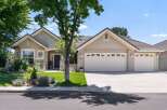 Discover this charming single-story home featuring a welcoming facade with stone accents and a well-maintained lawn.