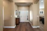 Step into a welcoming entryway featuring a classic white front door flanked by elegant sidelights.