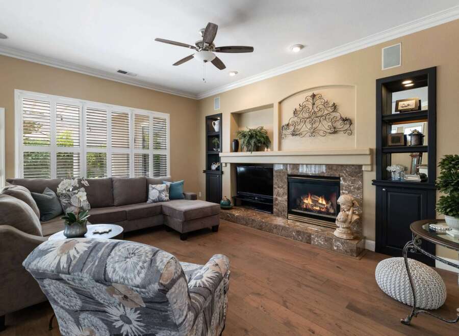 Experience luxurious living in this stunning living room, featuring a grand marble fireplace as the centerpiece.