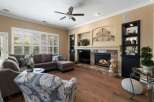Experience luxurious living in this stunning living room, featuring a grand marble fireplace as the centerpiece.