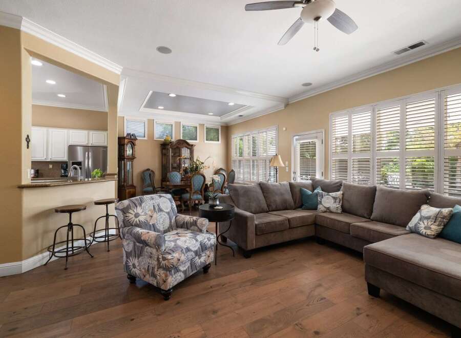 Experience comfortable living in this spacious open-concept home, featuring a modern kitchen with a breakfast bar and stainless steel appliances.
