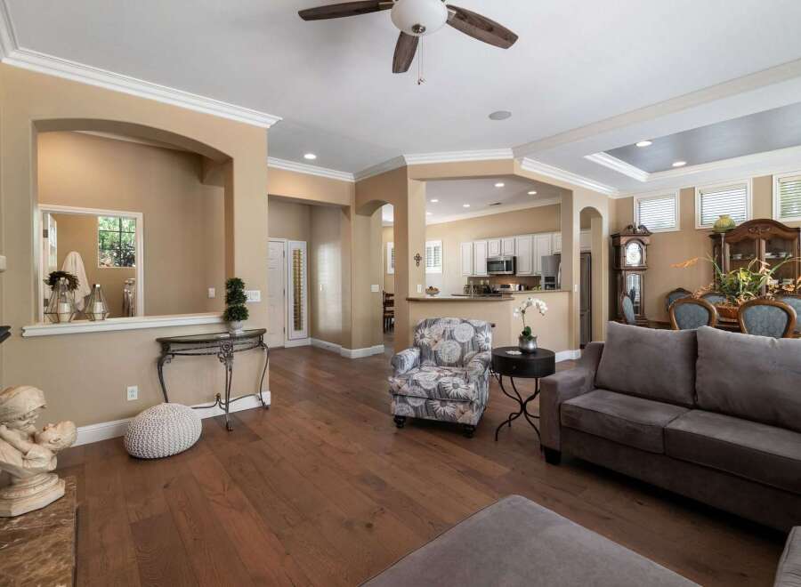 Step into this beautifully appointed living space, featuring an open-concept layout that seamlessly connects the living room to a modern kitchen.