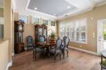 This elegant dining room features a grand grandfather clock and a matching china cabinet, perfect for showcasing your finest china.