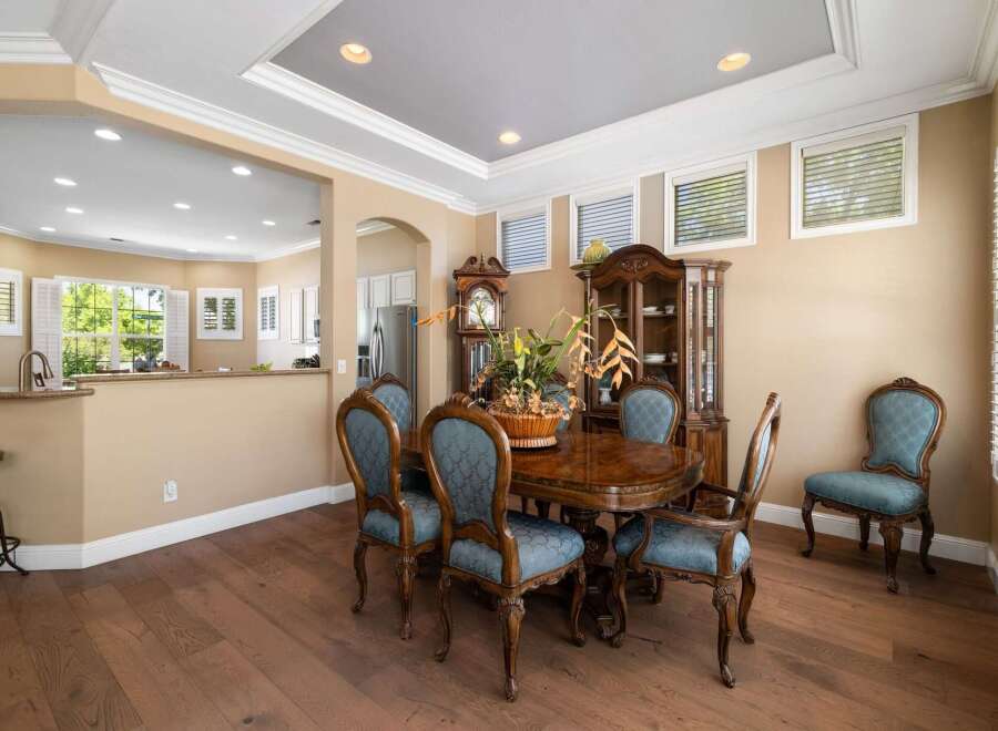 This elegant dining room features a classic oval dining table with ornate chairs, perfect for hosting memorable meals.