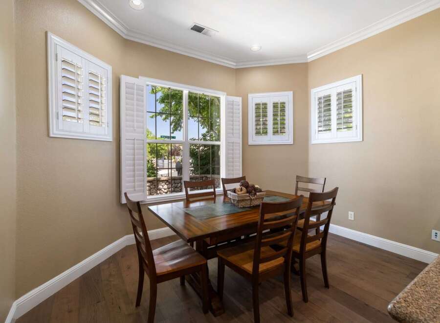 This dining room features a beautiful wooden table with six chairs, perfect for family gatherings.
