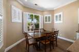 This dining room features a beautiful wooden table with six chairs, perfect for family gatherings.