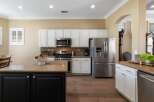 This spacious kitchen boasts elegant white cabinetry and granite countertops, perfect for any home chef.