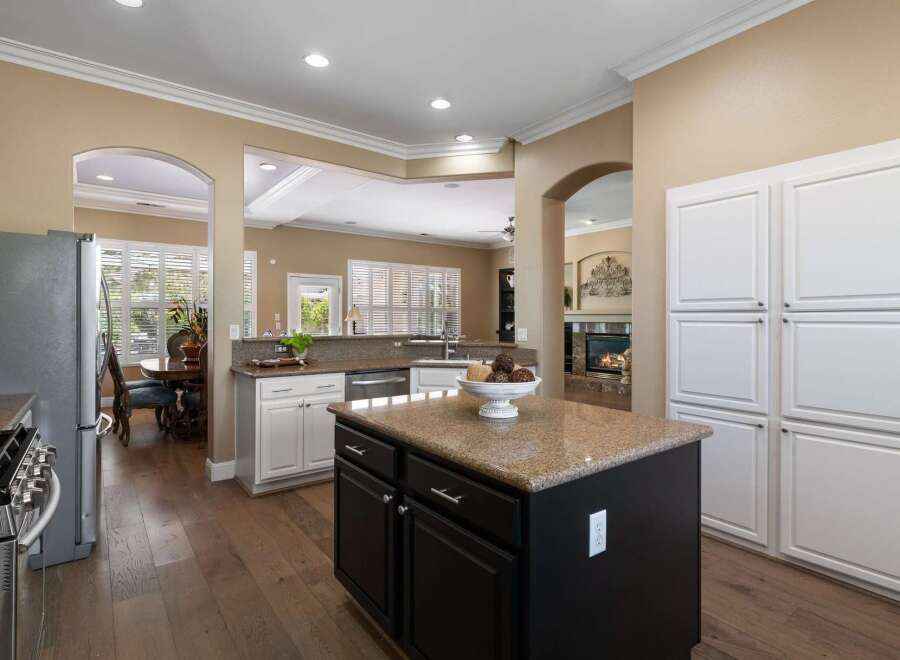 This spacious kitchen boasts granite countertops and a large island, perfect for meal preparation and entertaining.