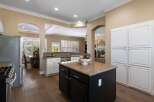 This spacious kitchen boasts granite countertops and a large island, perfect for meal preparation and entertaining.