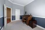This home office features a classic roll-top desk and a matching file cabinet, perfect for a productive workspace.