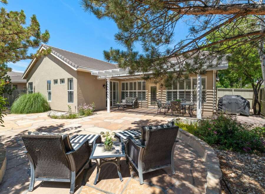Enjoy outdoor living in this spacious backyard featuring a large stone patio perfect for entertaining.