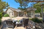 Enjoy outdoor living in this spacious backyard featuring a large stone patio perfect for entertaining.