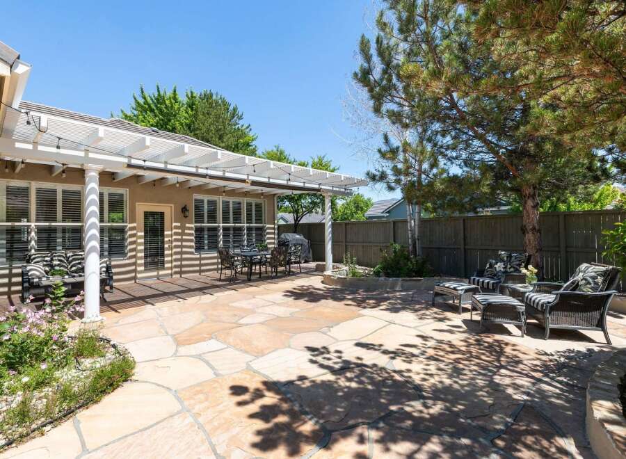 Enjoy outdoor living in this spacious backyard featuring a large flagstone patio perfect for entertaining.