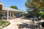 Enjoy outdoor living in this spacious backyard featuring a large flagstone patio perfect for entertaining.