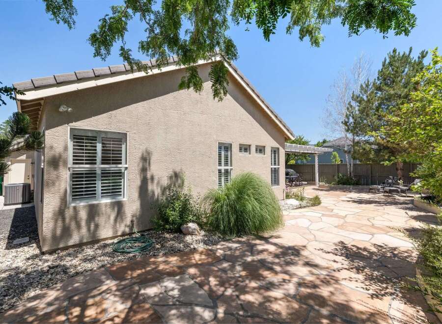 Enjoy outdoor living in this spacious backyard featuring a large flagstone patio perfect for entertaining.