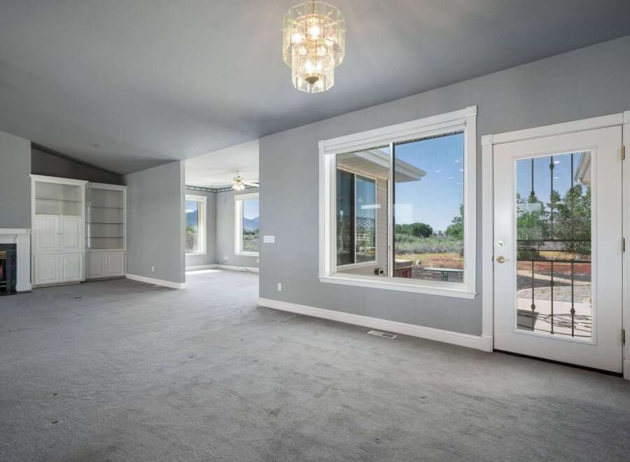 Step into this spacious living area featuring a cozy fireplace and built-in shelving, perfect for displaying your favorite items.
