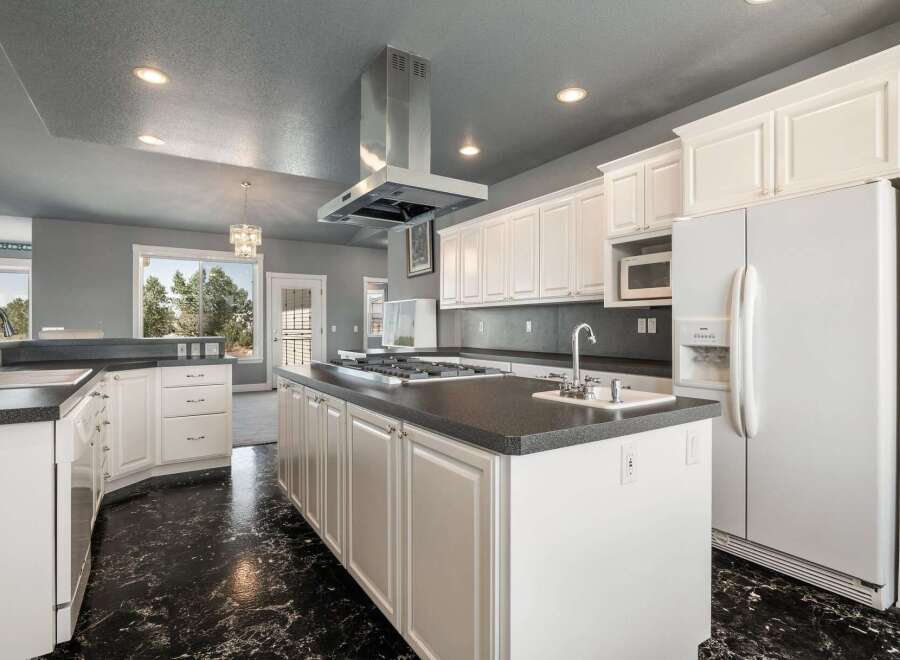 This spacious kitchen features a large island with a gas stovetop, perfect for culinary enthusiasts.