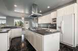 This spacious kitchen features a large island with a gas stovetop, perfect for culinary enthusiasts.