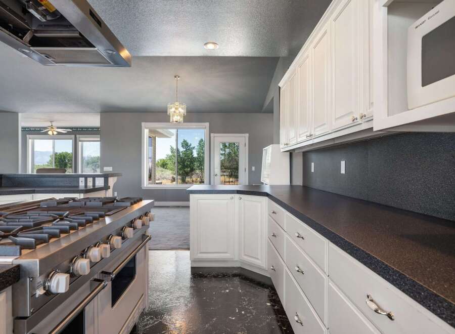 Experience culinary excellence in this stunning kitchen, featuring a professional-grade gas range and ample counter space perfect for meal preparation.
