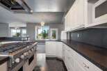 Experience culinary excellence in this stunning kitchen, featuring a professional-grade gas range and ample counter space perfect for meal preparation.
