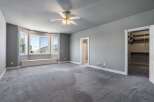 This spacious bedroom features a large bay window with a built-in bench, perfect for enjoying the natural light and scenic views.
